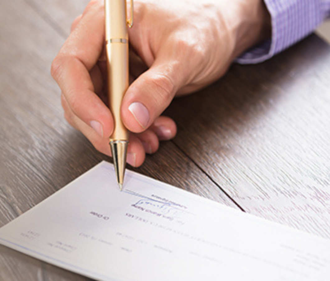 A person writing a cheque