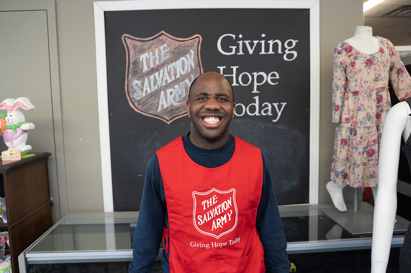 A thrift store employee smiling